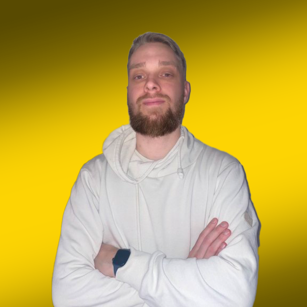 Person in a white hoodie with folded arms against a yellow background.