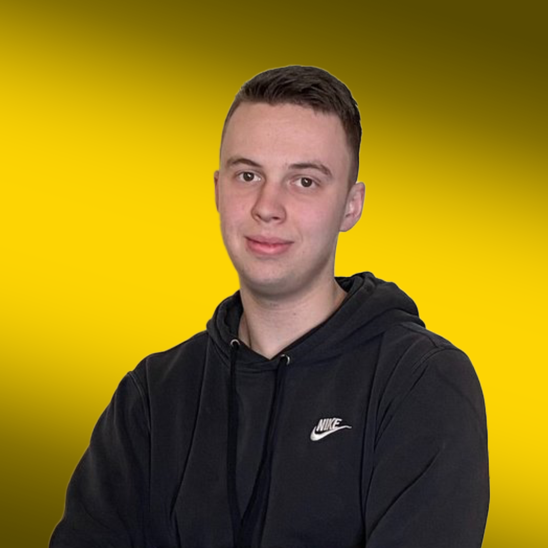 Person in a black Nike hoodie against a yellow background.