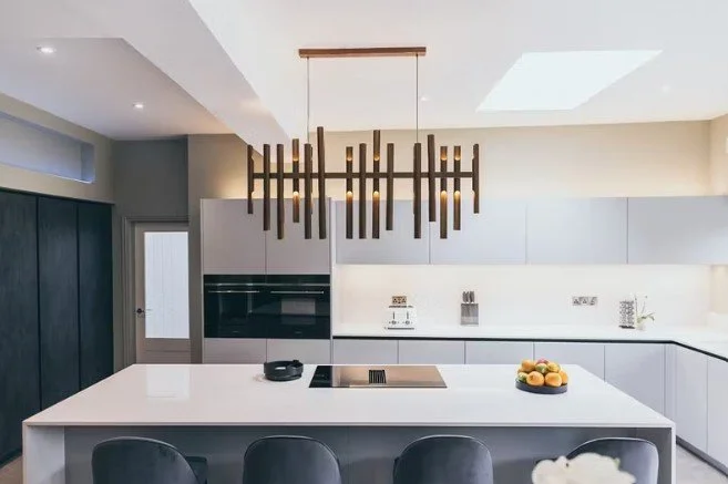 Bespoke luxury kitchen with central island, premium cabinetry and designer lighting.