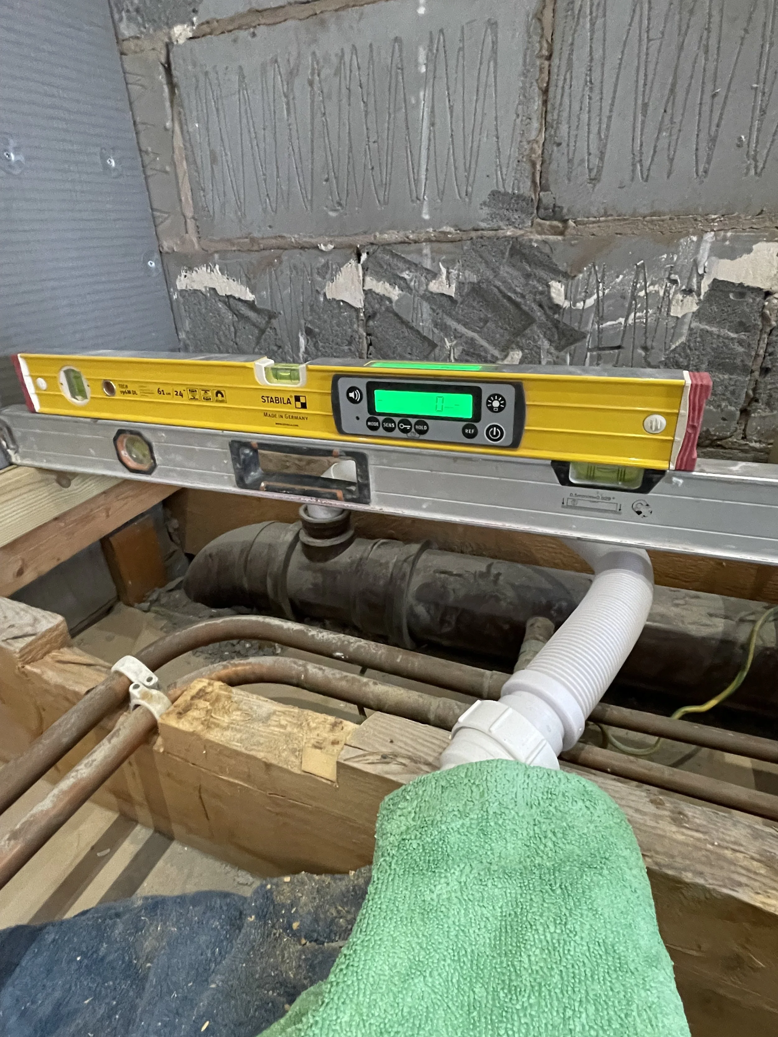Precision bathroom renovation work showing professional preparation and installation by NWTI.