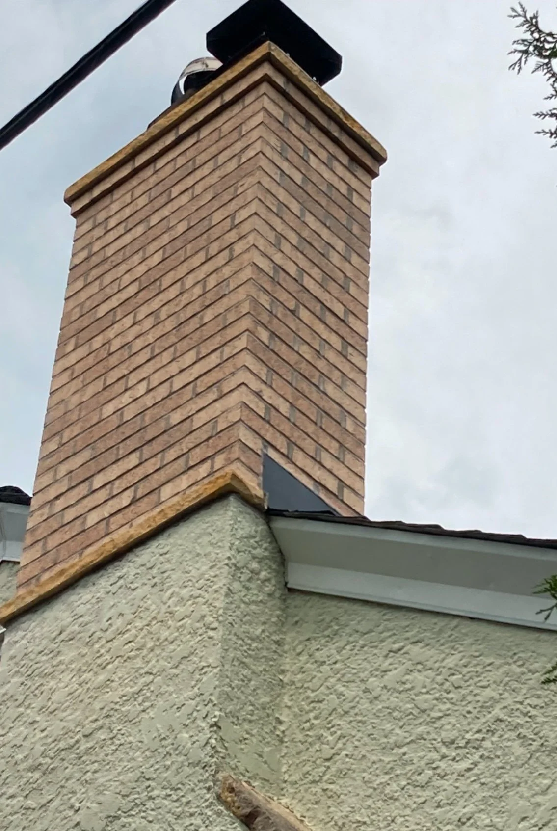 Tan brick chimney repair and restoration.