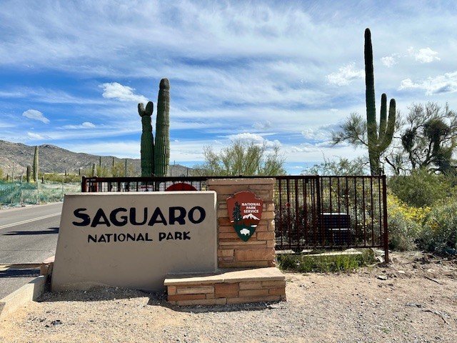 Entrance sign for Saguaro National Park, Arizona, photographed during an electric vehicle road trip through the Sonoran Desert.