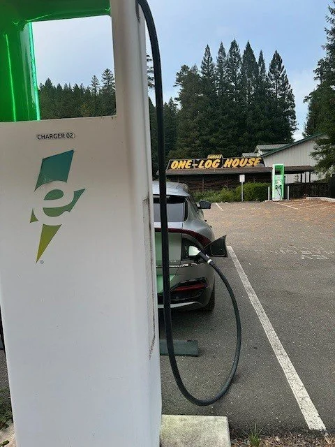 Kia EV6 electric vehicle charging at an Electrify America station near Garberville, California during a road trip