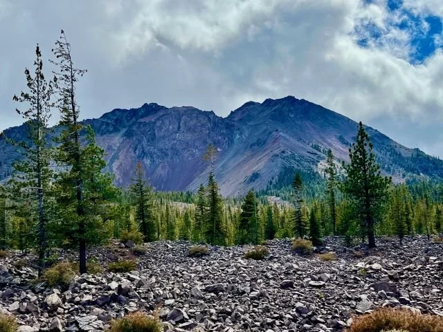 Lassen Peak towering behind a rugged field of volcanic rocks in Lassen Volcanic National Park