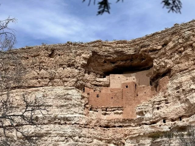 Montezuma Castle cliff dwelling built into a limestone rock wall above Beaver Creek in Arizona, showcasing ancient Sinagua architecture high above the desert landscape