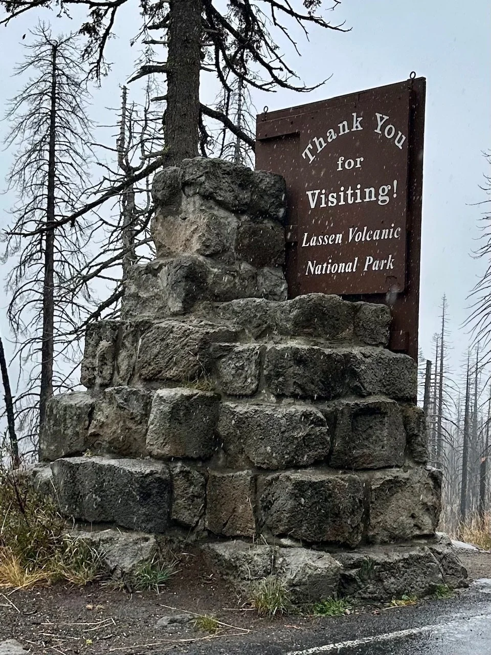 Thank You for Visiting exit sign at Lassen Volcanic National Park surrounded by pine trees along the park highway
