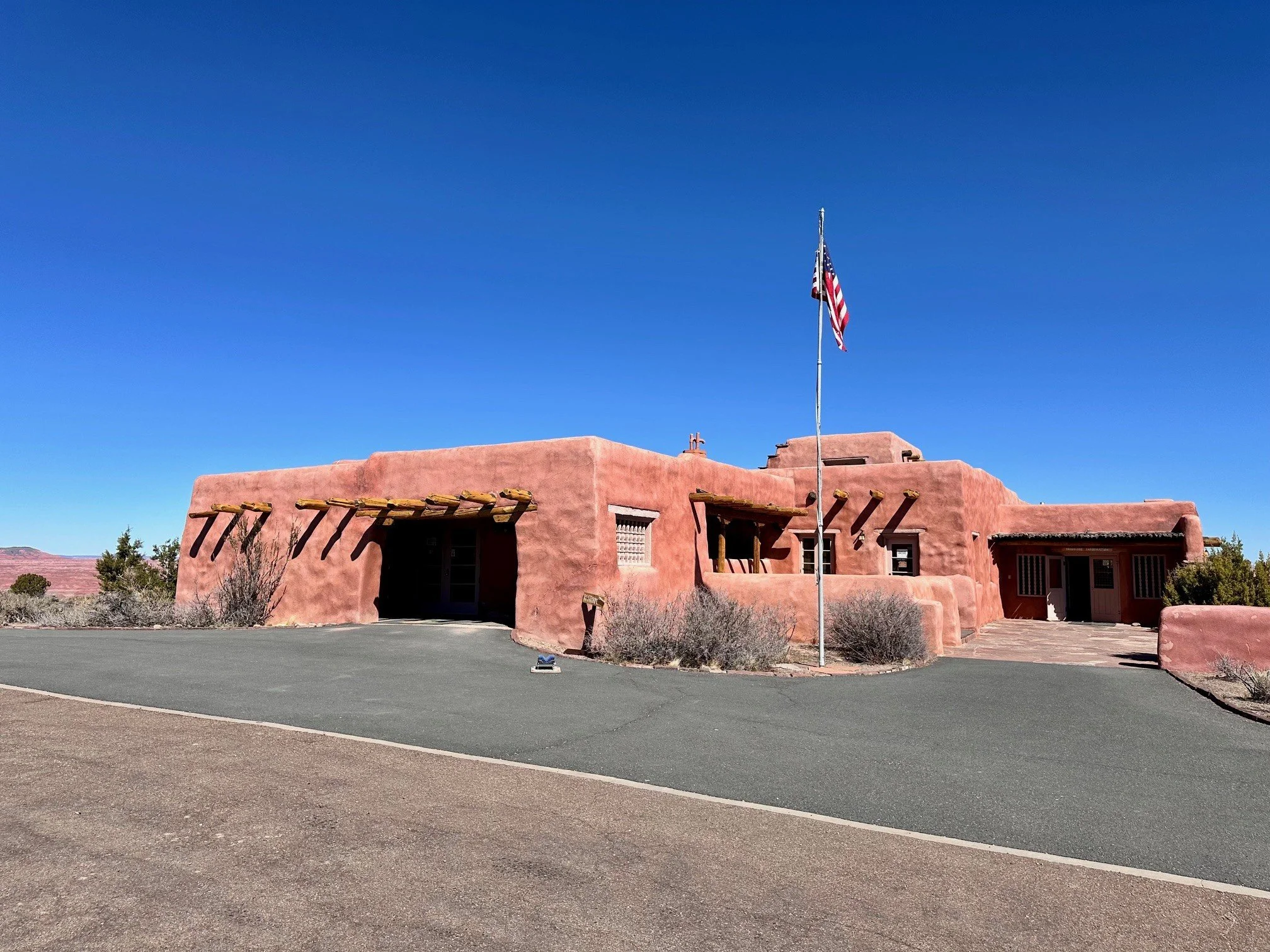 The Painted Desert Inn at Petrified Forest National Park, glowing against the desert landscape with its historic architecture and wide‑open Painted Desert views.