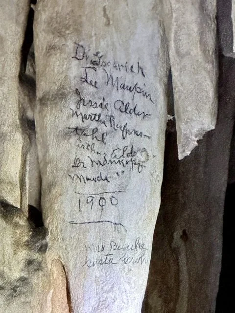 Stalactite inside Fisher Cave showing historic graffiti left by visitors around 1900.