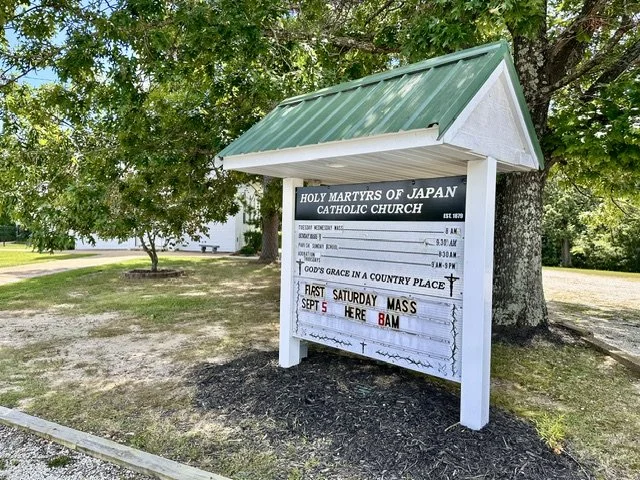 Church of the Holy Martyrs of Japan sign in Japan, Missouri, highlighting the parish that inspired the community's distinctive name.