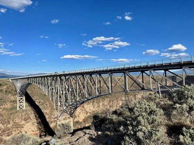 Side view of the Rio Grande Gorge Bridge stretching across the Rio Grande Gorge in the Rio Grande del Norte National Monument.