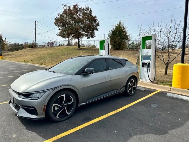 Kia EV6 charging at an Electrify America station during a road trip, ensuring reliable fast charging for electric vehicle travel across the country.