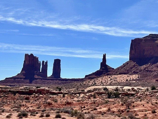 Iconic red sandstone buttes rise above the desert floor in Monument Valley, Arizona, along one of the Southwest's most scenic road-trip routes.