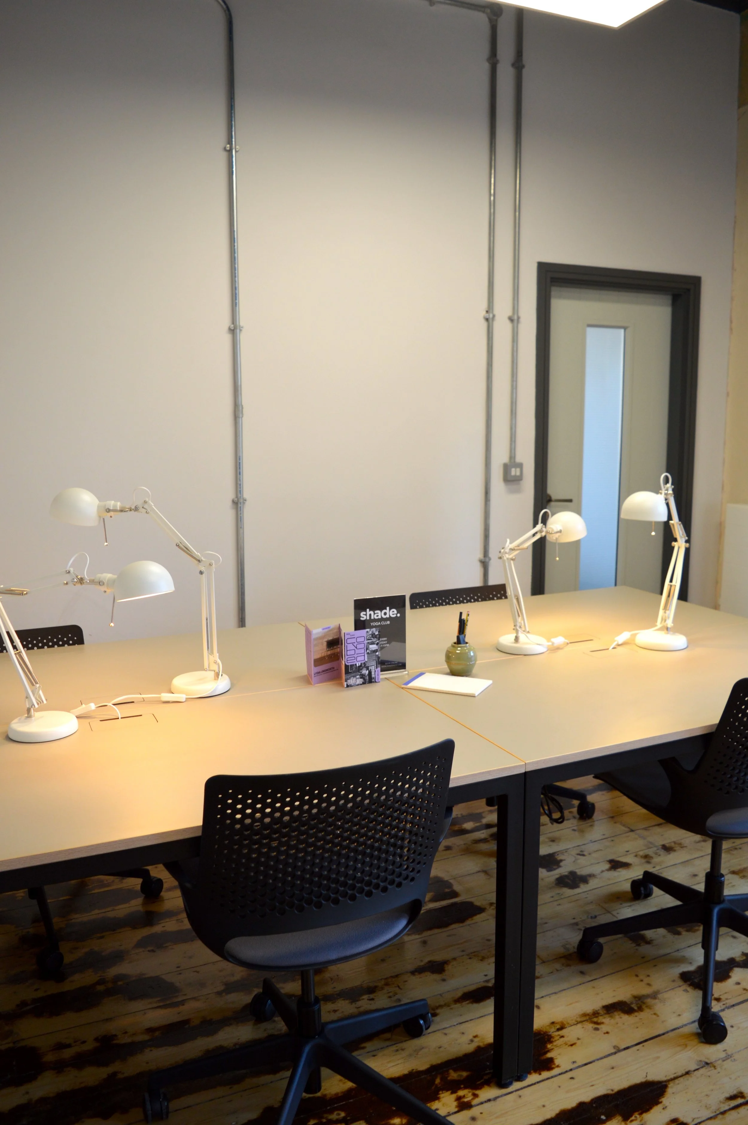 A brightly lit desk in a private workspace.