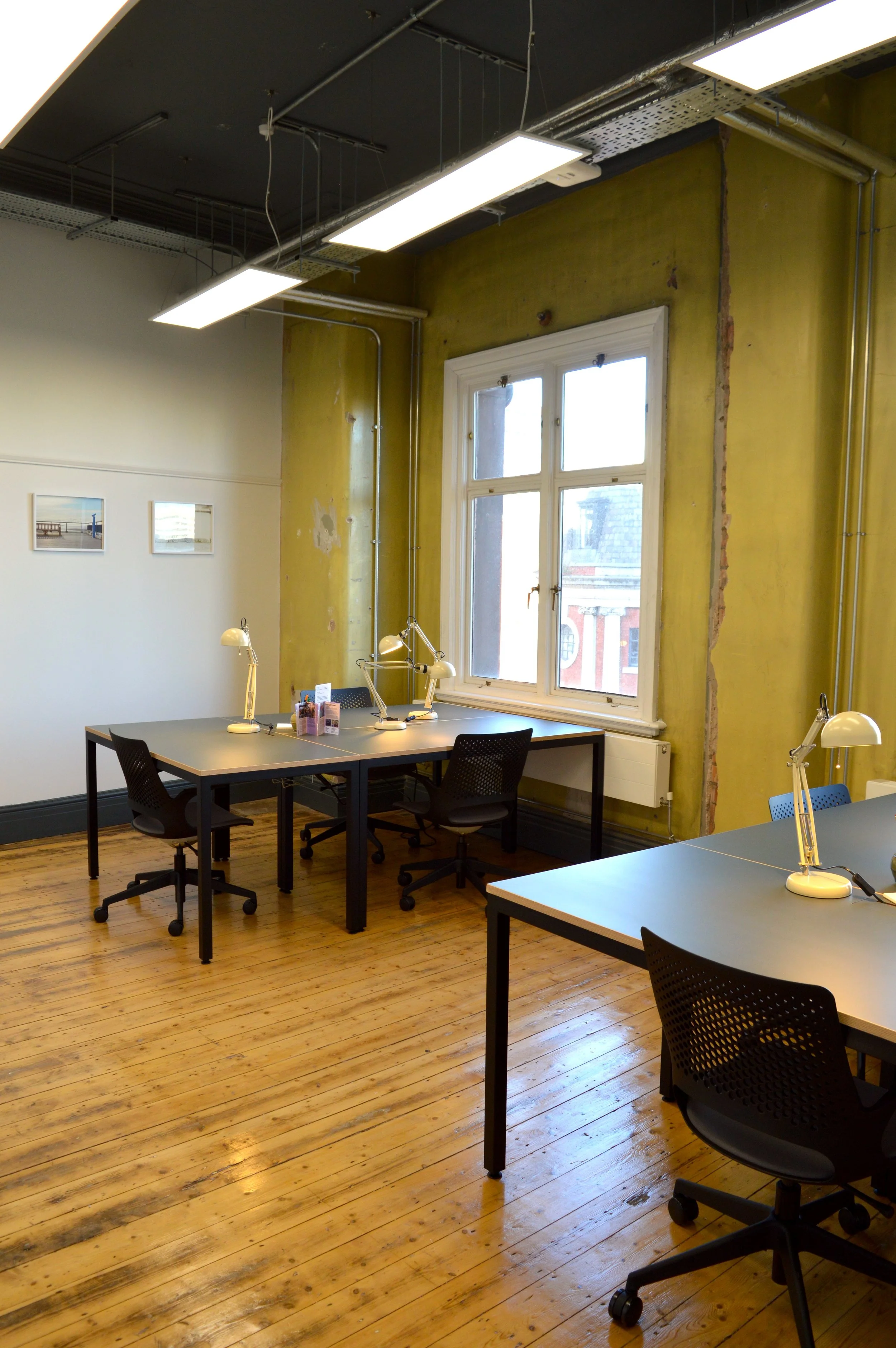 A large private office in a historic Manchester building with wooden floors and original paintwork.