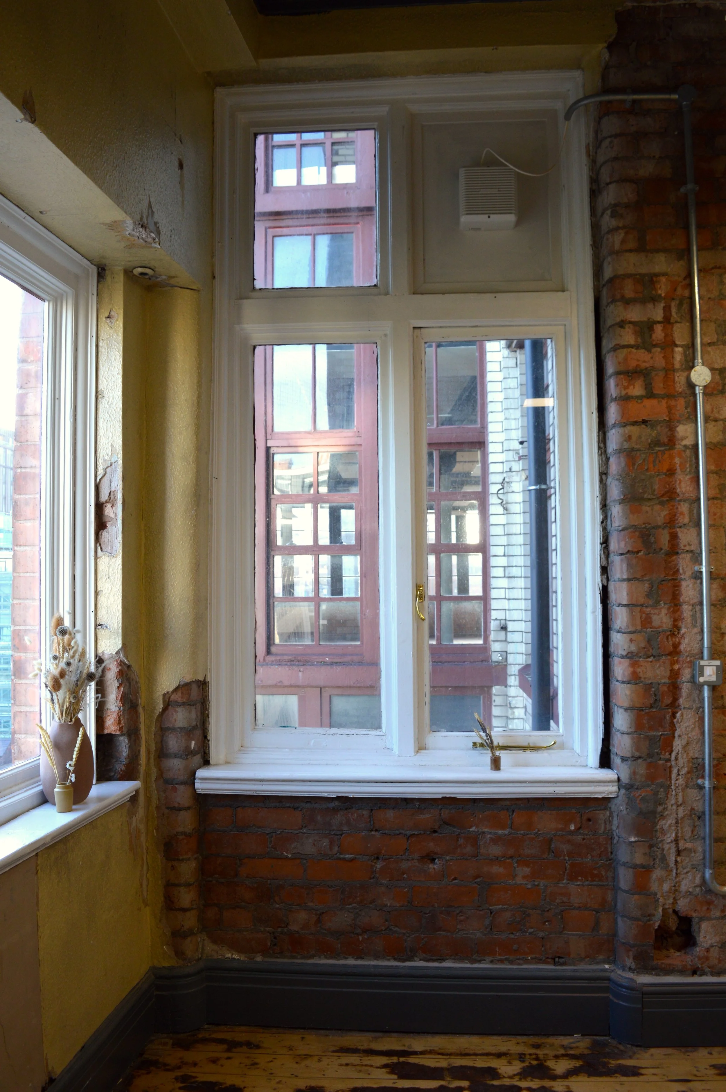 View of Manchester's red brick architecture from the window of a private studio in SEESAW..
