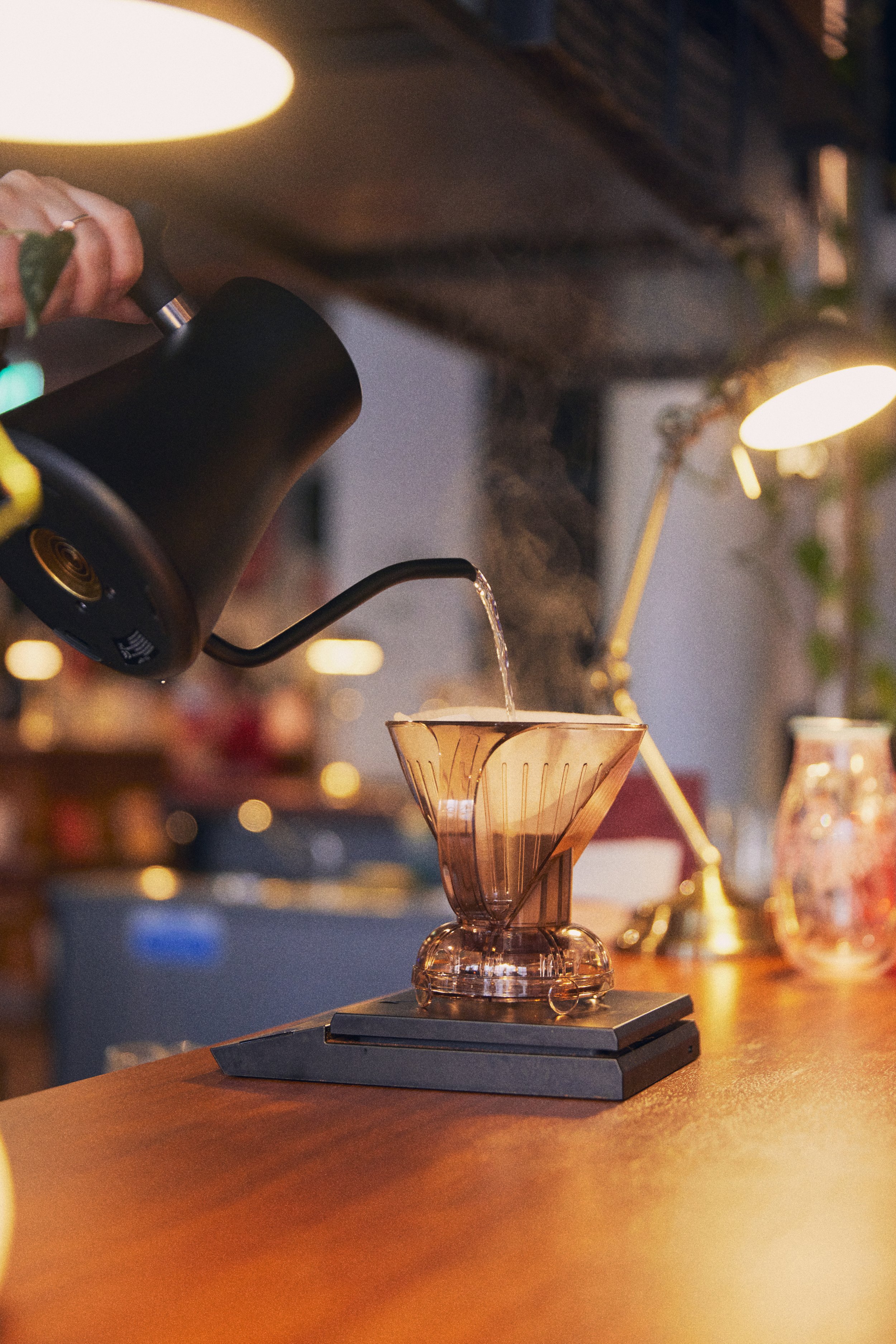 A V60 coffee being poured in SEESAW Cafe.
