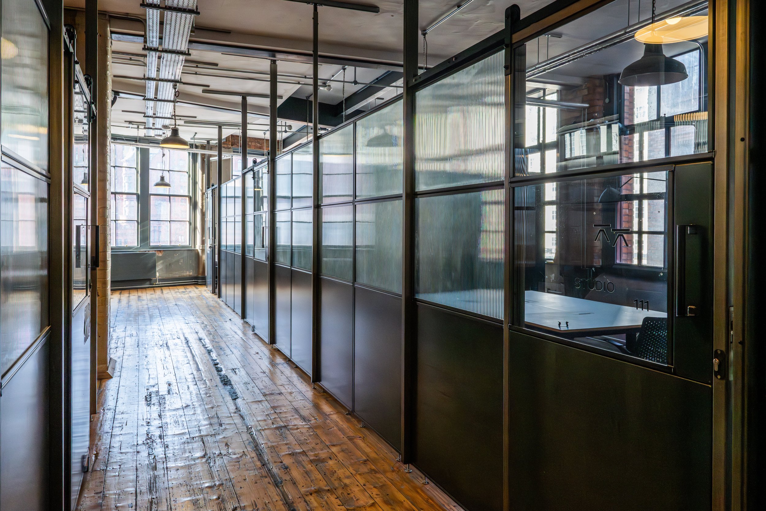 Partitioned studio space in a Manchester red brick office building.