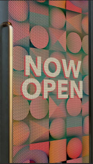 Colorful wall with a sign that says 'Now Open' in large white letters.