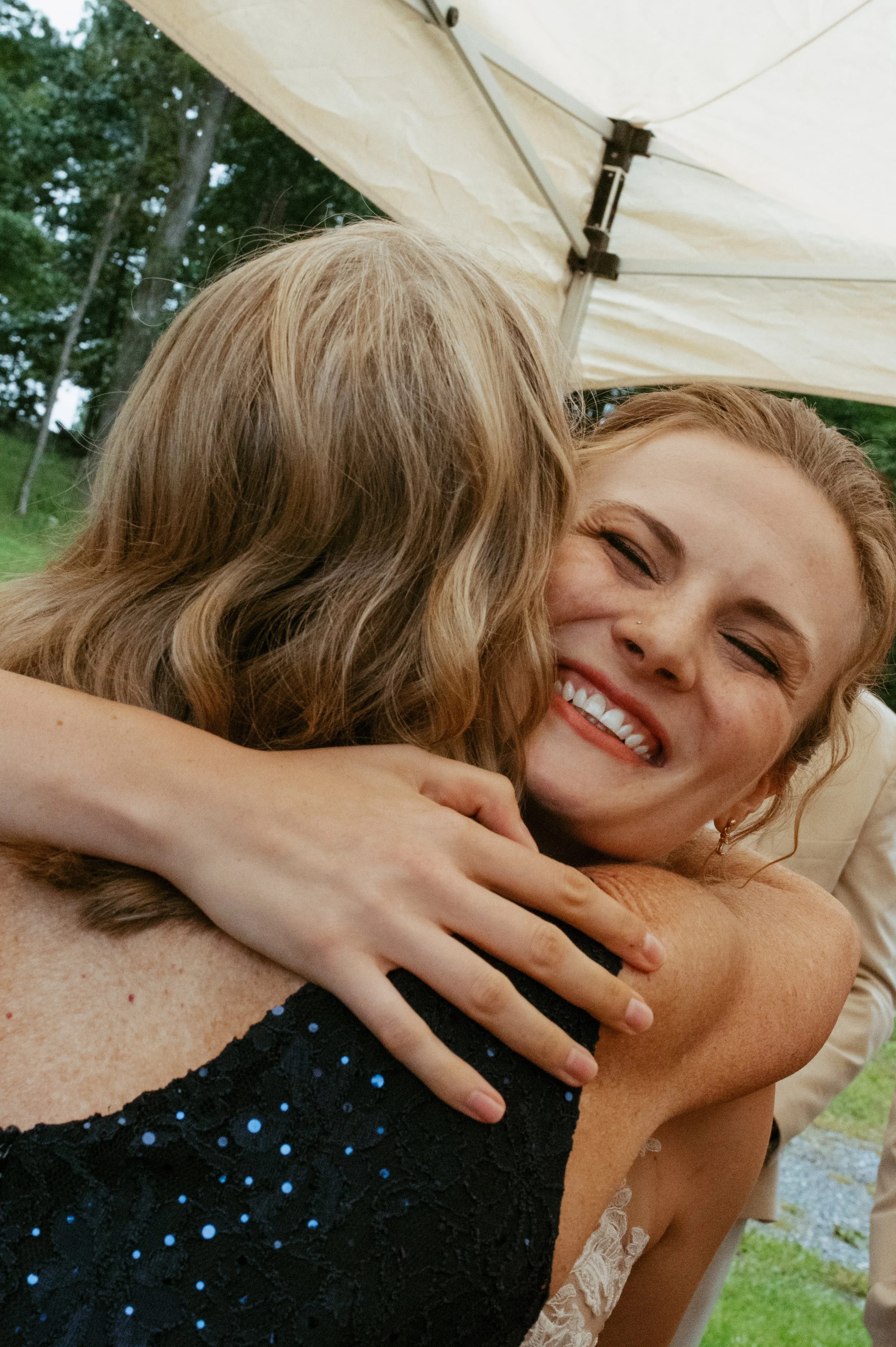 bride hugging mom and smiling after saying i do