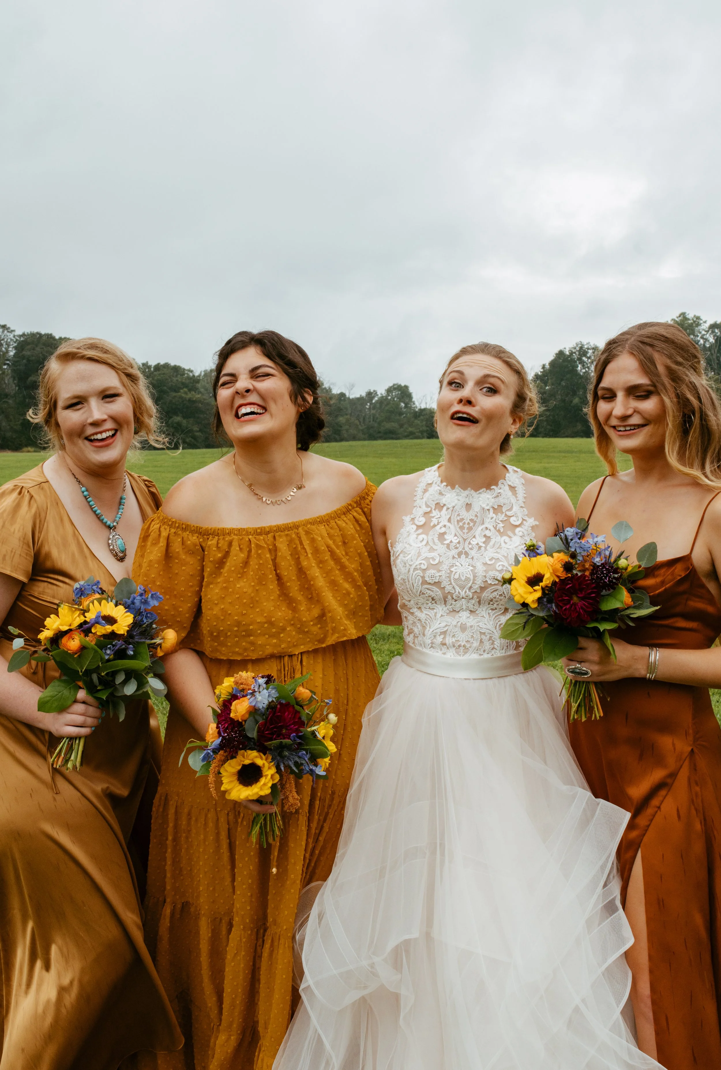 bridal party smiling and being goofy candidly at caboose farm