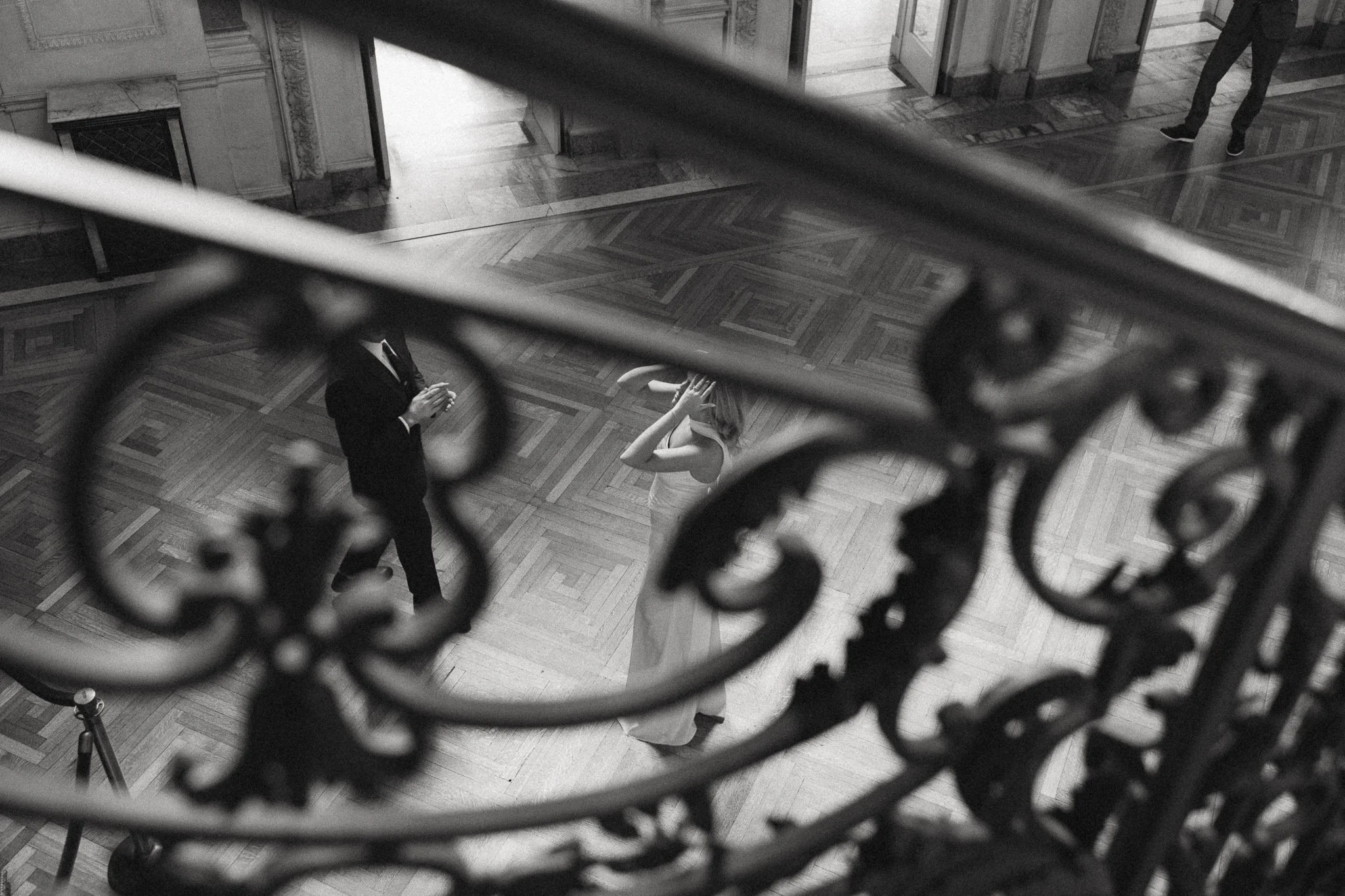 an engaged couple walking around larz anderson house together getting their engagement photos taken
