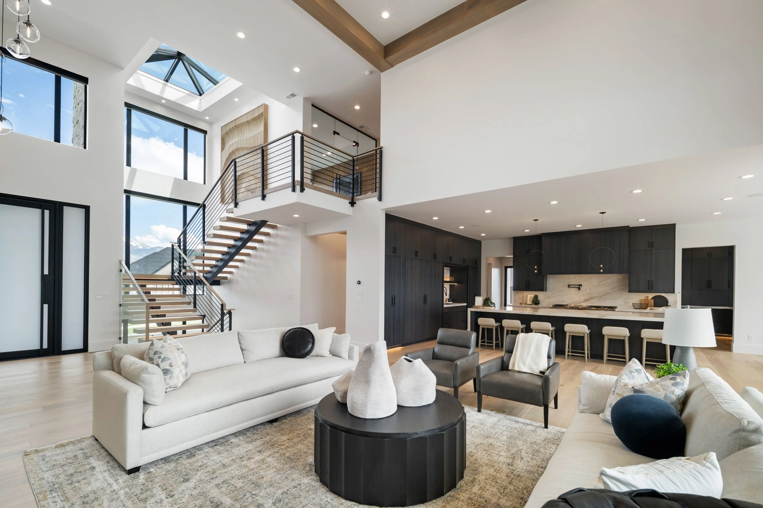 Interior view of a house under construction with exposed wooden framing, partially installed roof, and daylight coming through an opening.