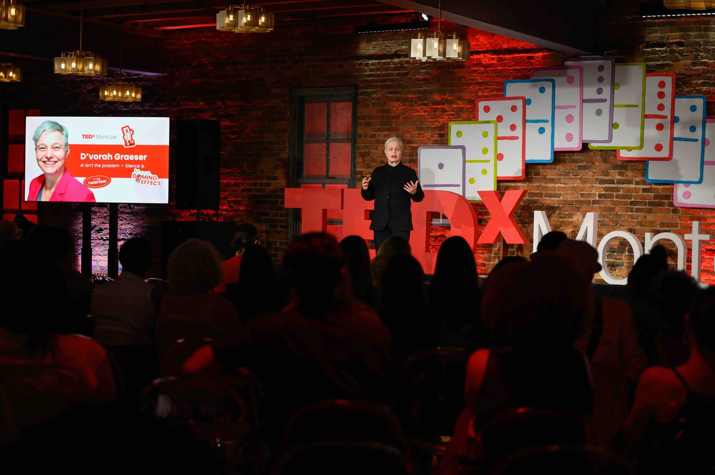 Audience watching a presentation on the TEDx Montclair stage