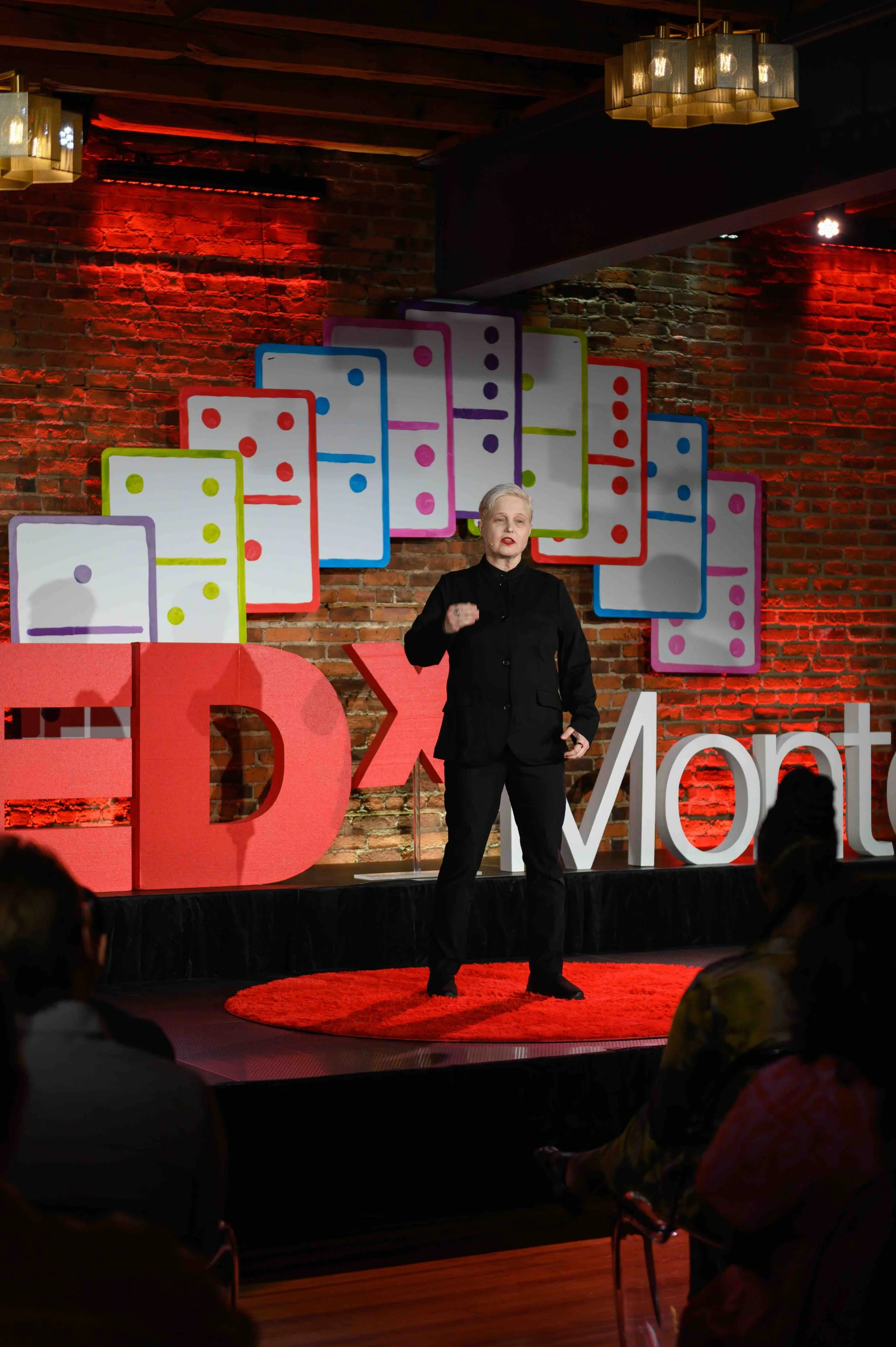 Speaker standing on the TEDx Montclair stage