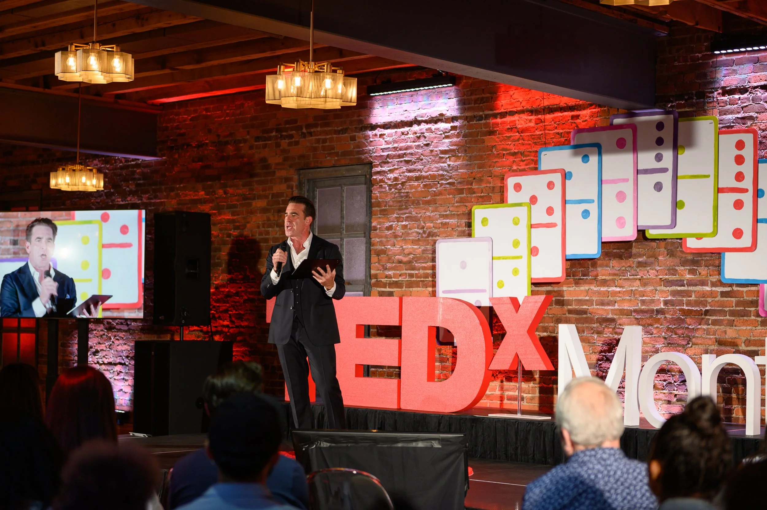 Speaker standing on the TEDx Montclair stage
