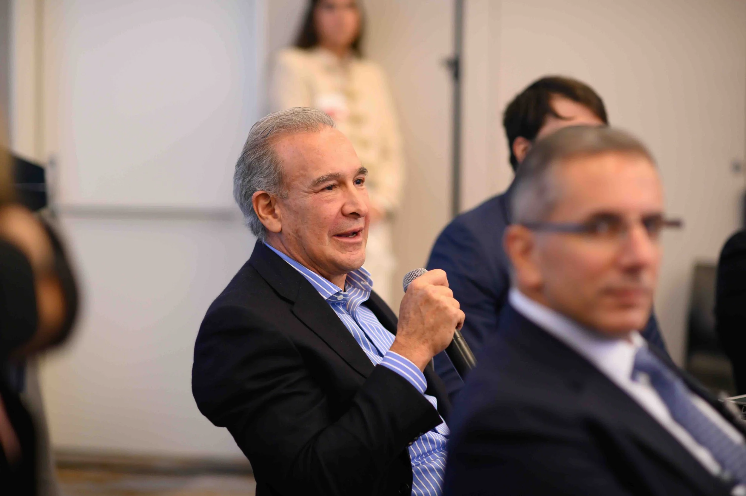 Close-up of a speaker gesturing while talking to the Hines symposium audience