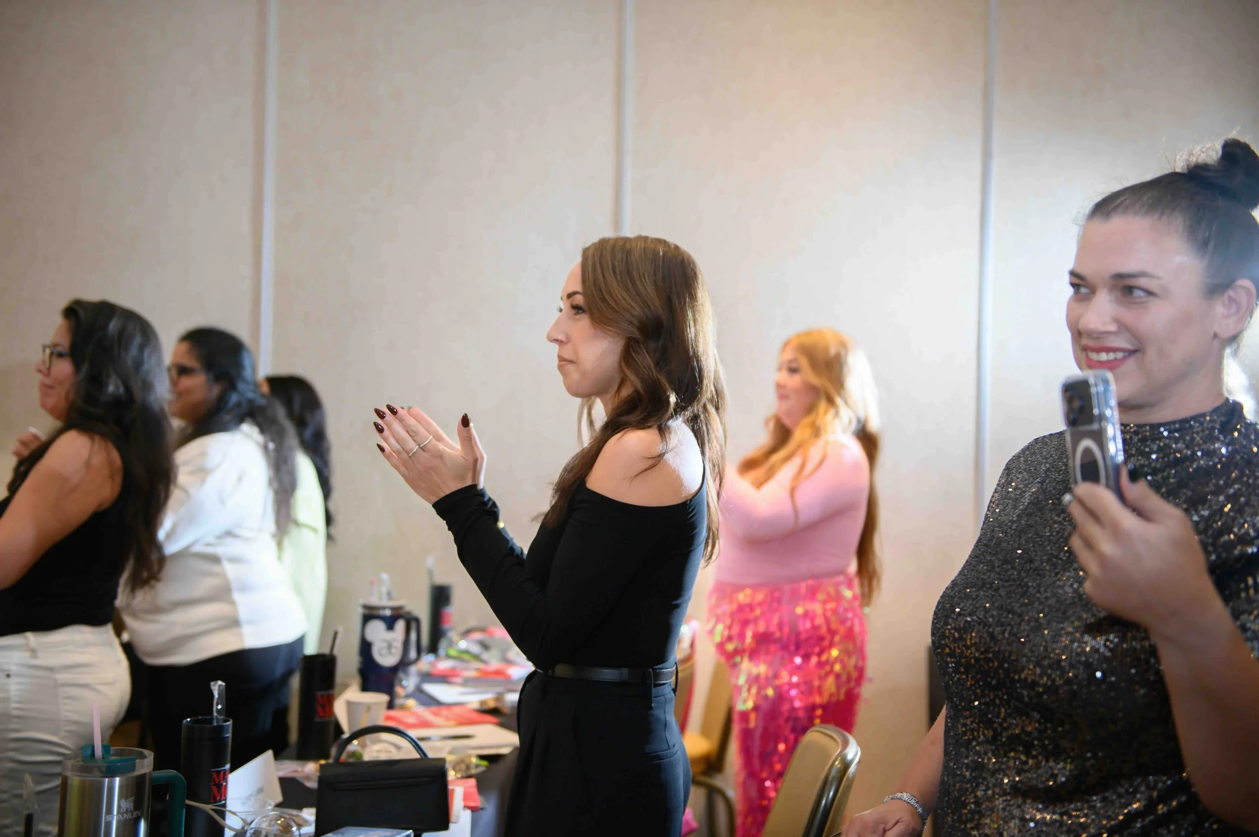 Woman in black speaking to attendees at the event