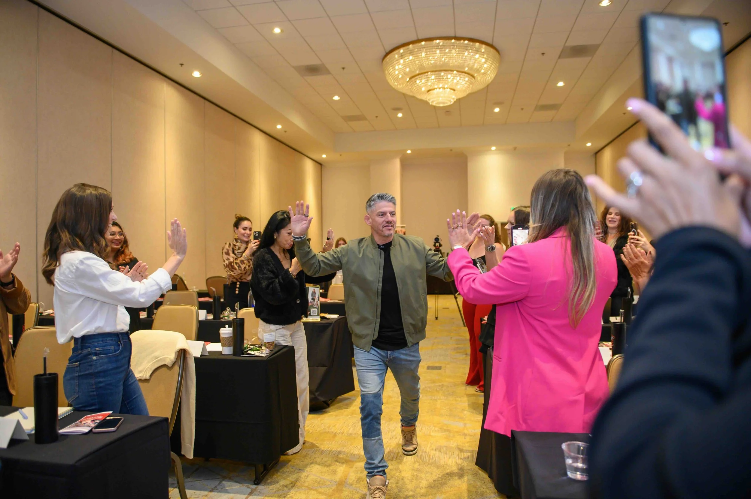 Attendees mingling in the ballroom at She's Made For More