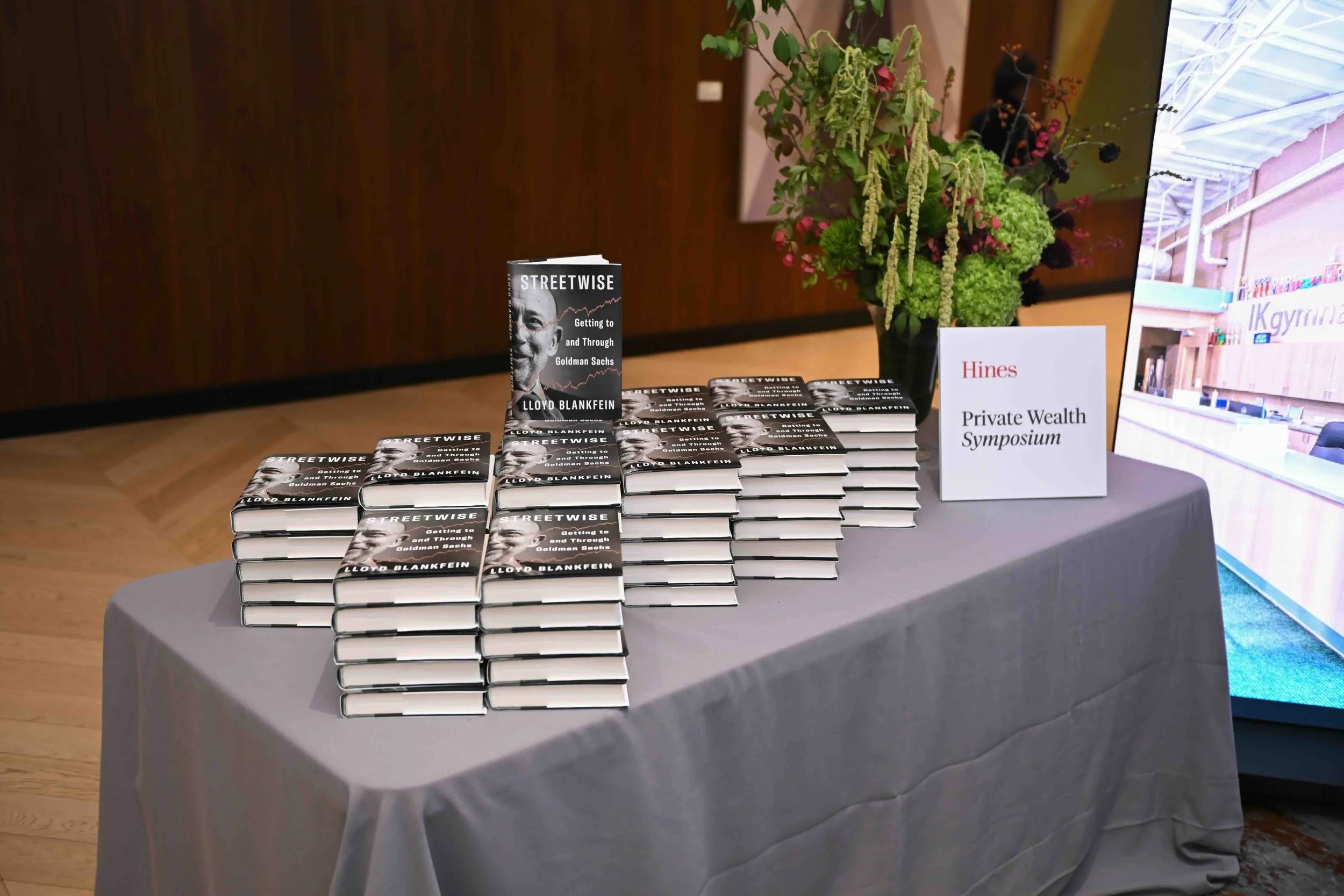 Table of books displayed with greenery at the Hines symposium