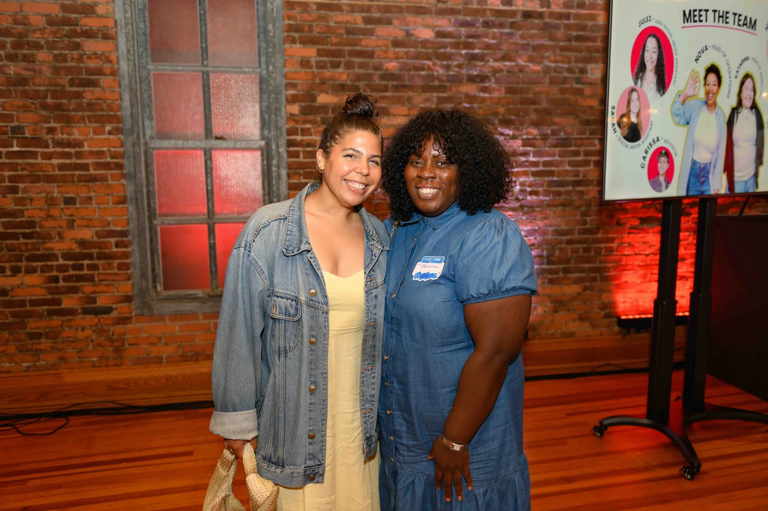 Two women smiling together at TEDx Montclair