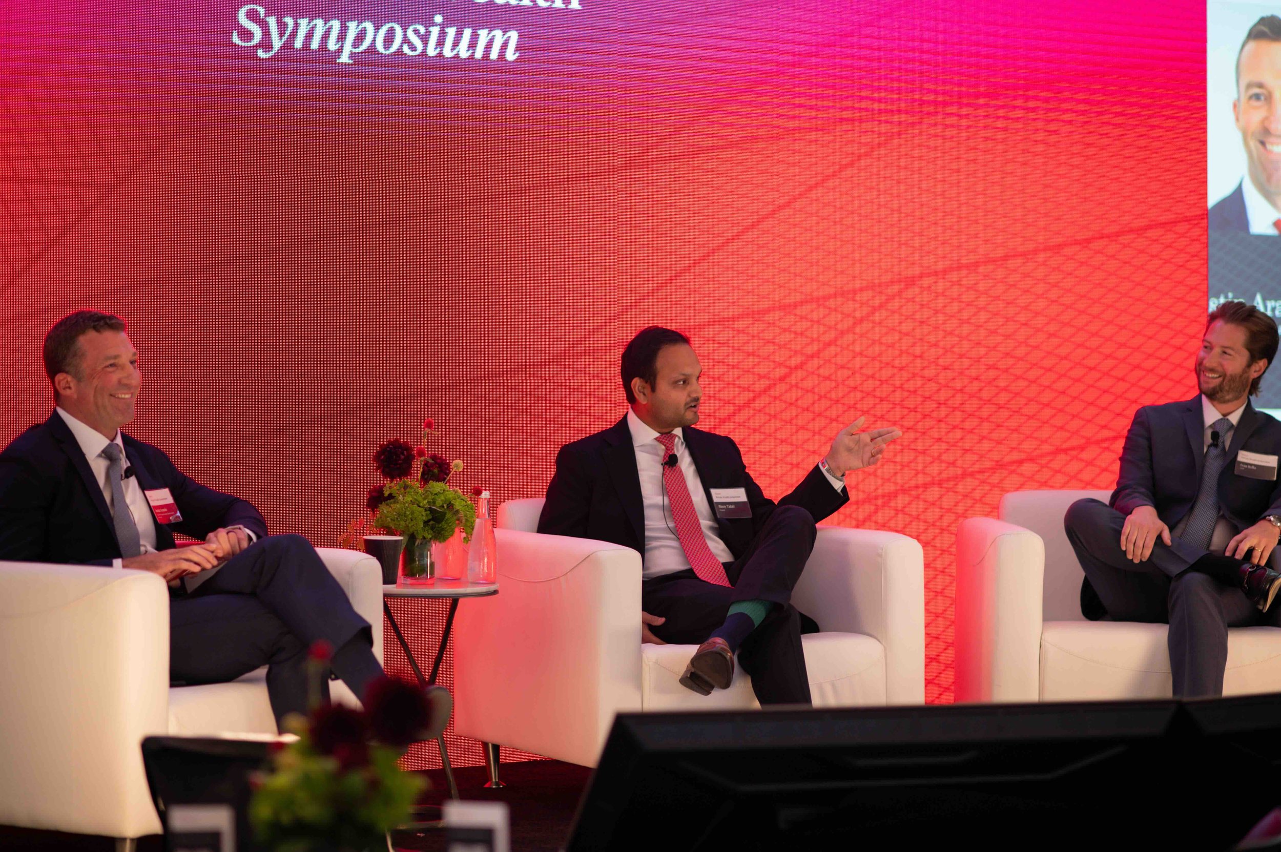 Panelist seated on stage during a discussion at the Hines symposium