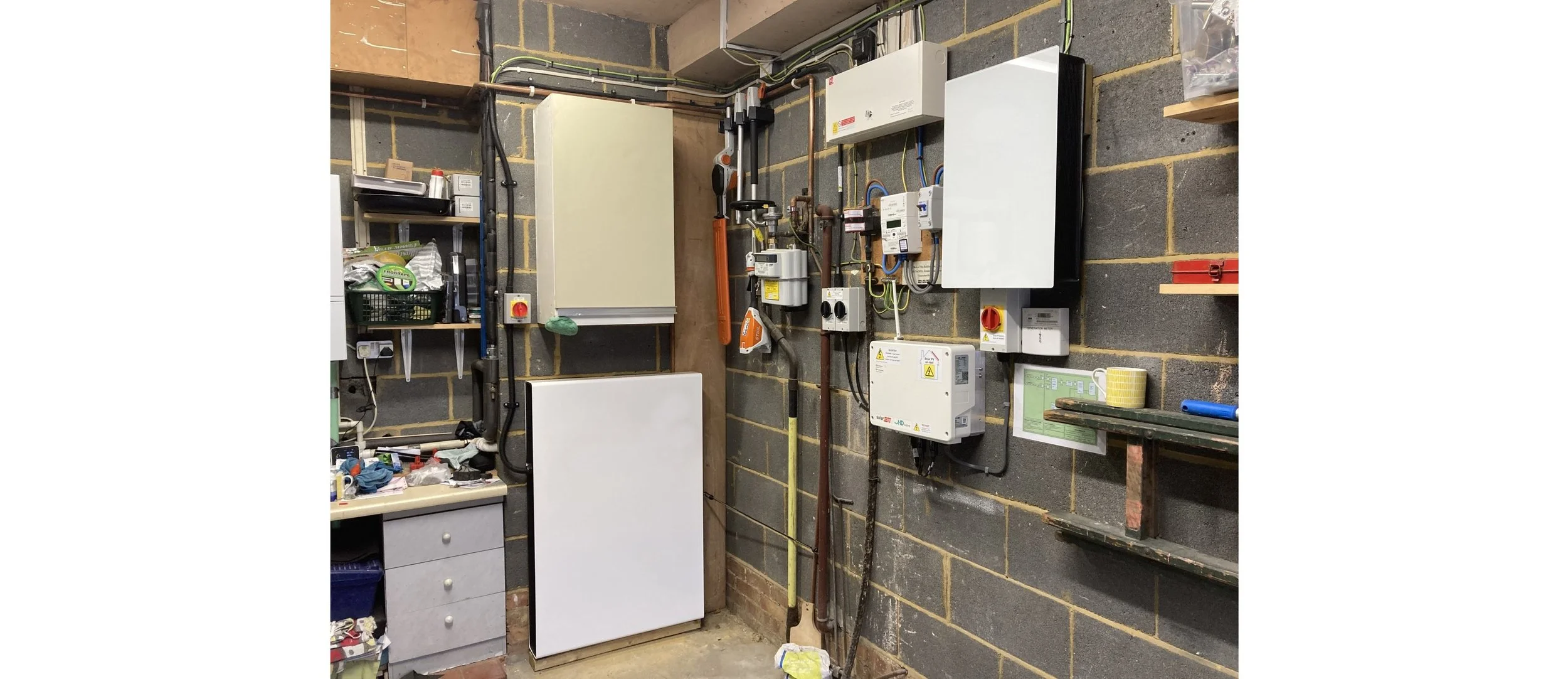 Complex traditional solar battery installation taking up interior wall space with extensive wiring.