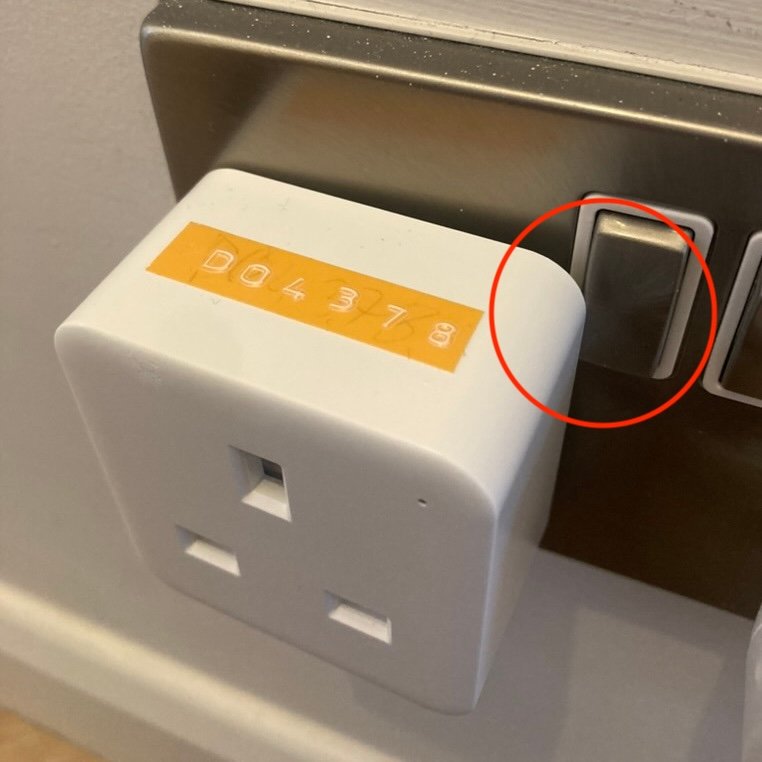 Beta prototype of the Windfall smart plug undergoing fit and dimension testing in a standard UK wall socket.