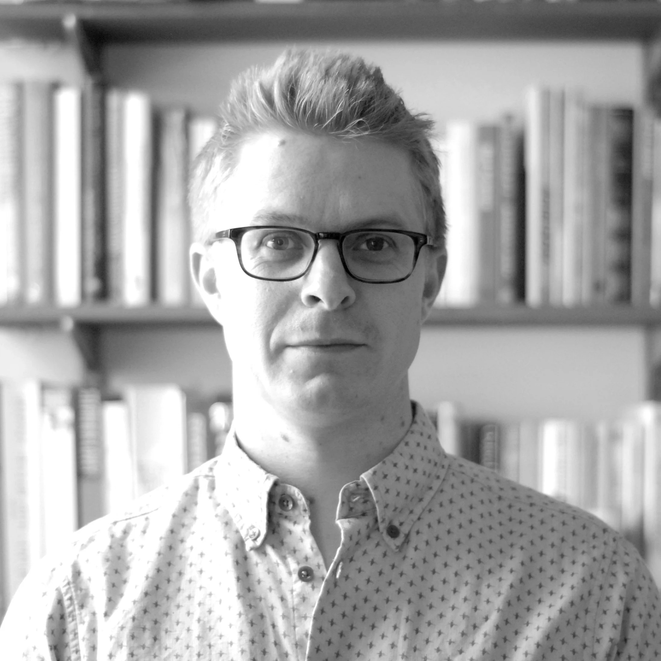 Black and white portrait photograph of Rob Hallifax, co-founder and CPO of Windfall Energy.