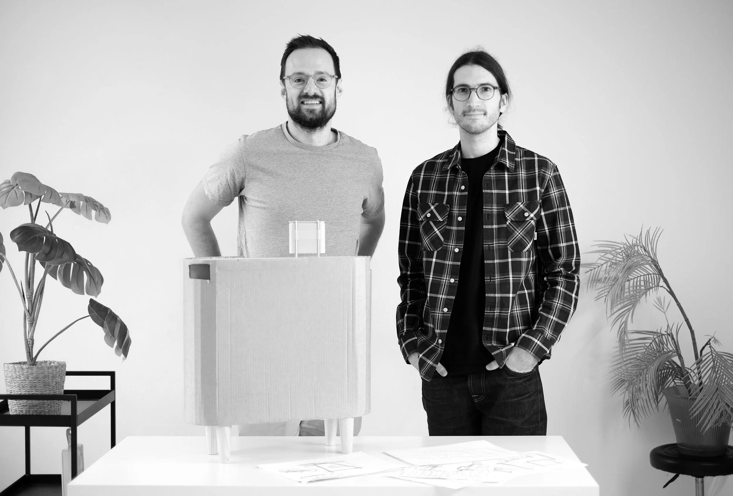 Designers Ben King and Victor Gil presenting miniature and full-scale cardboard prototypes of the Windfall home battery.