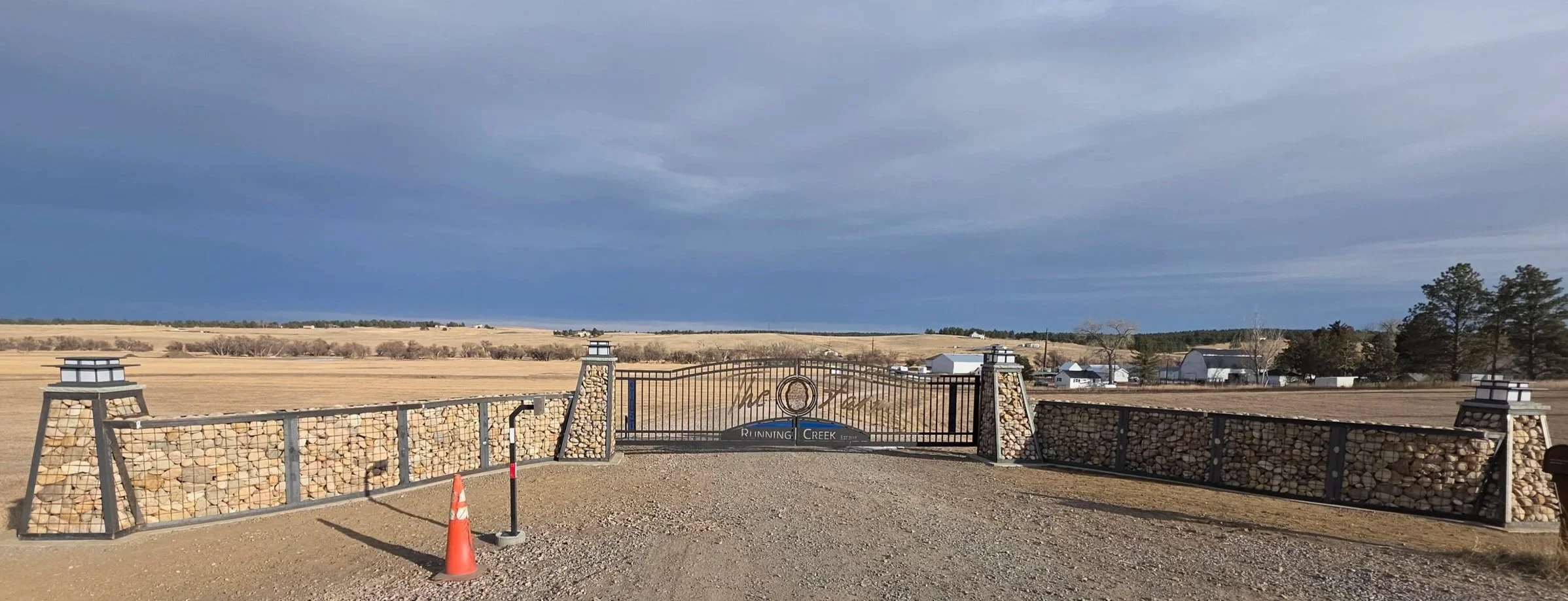 Custom Entry with double swing gate and Gabions framing each side.