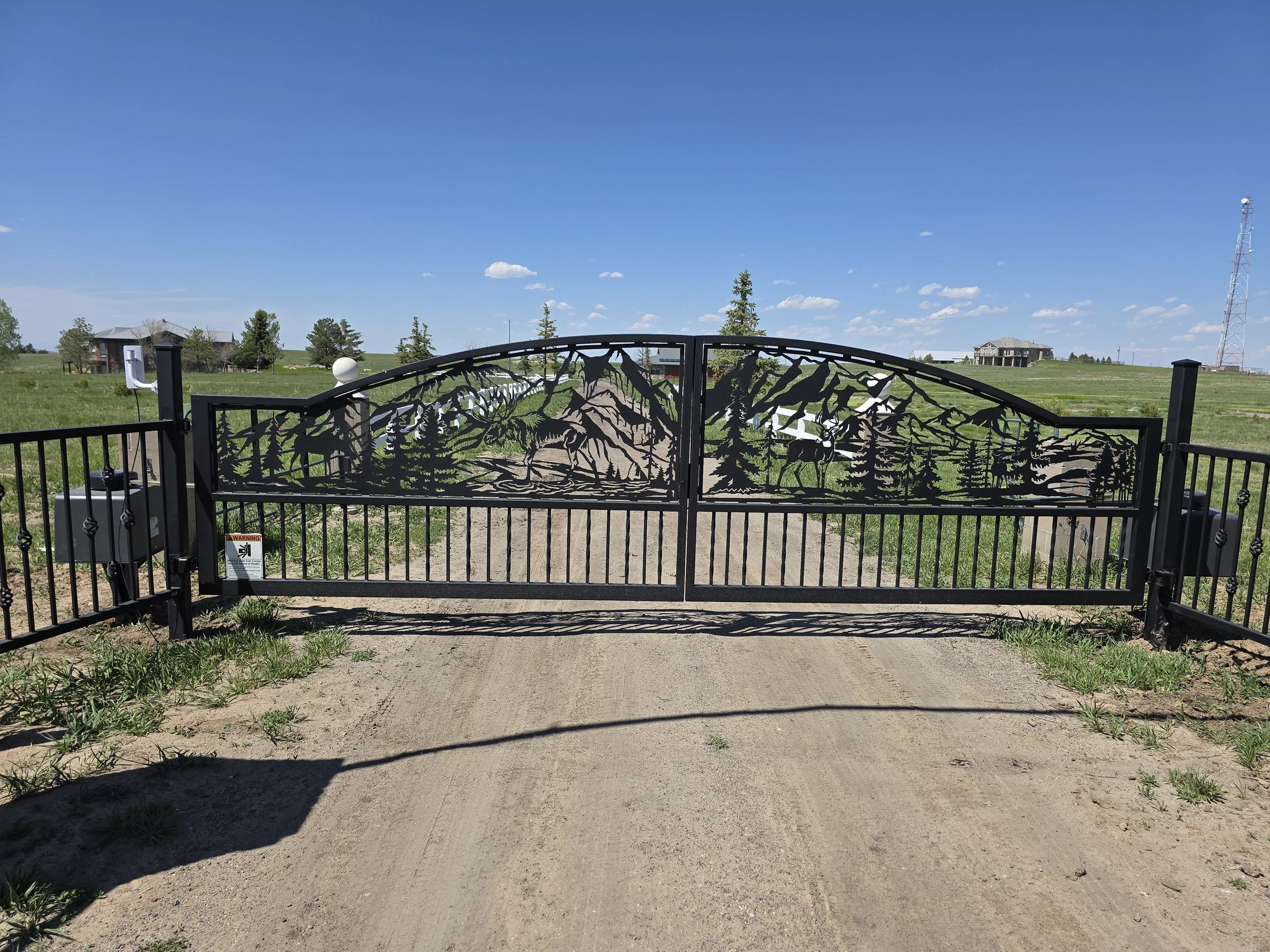 Custom graphic gate with pedestal operators in high wind area.