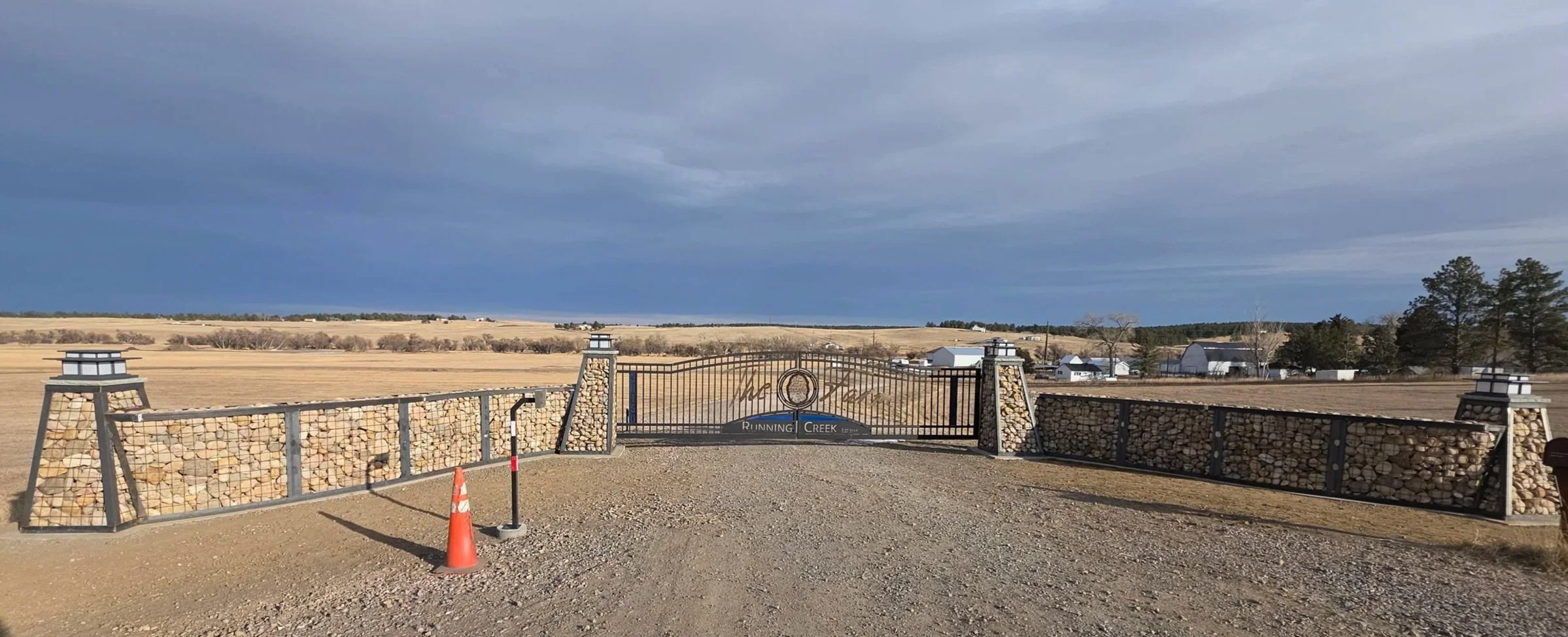 "The Farm" gate entryway with Gabions on both sides