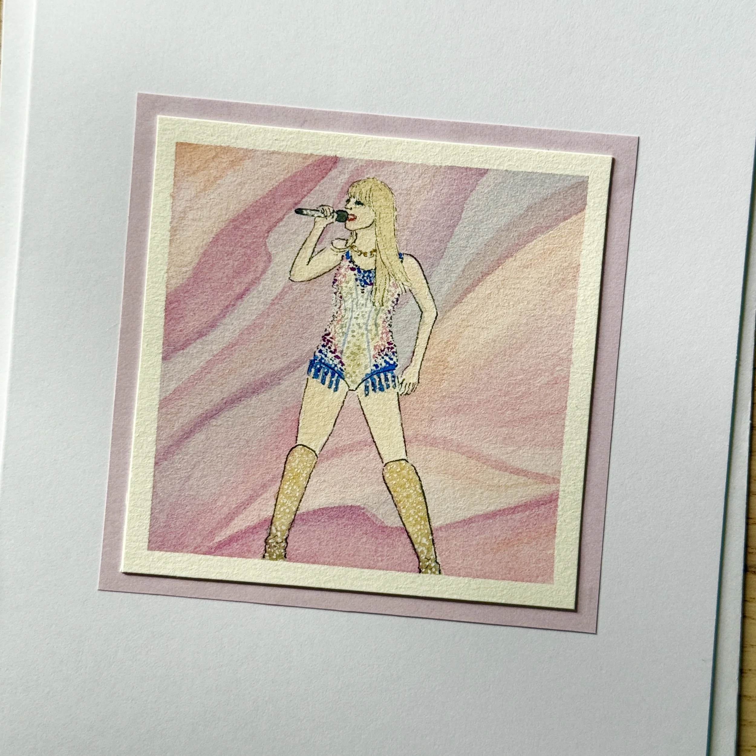 Watercolour illustration of Taylor Swift wearing a Lover-themed colourful, sparkly outfit and knee-high boots, singing into a microphone on stage.