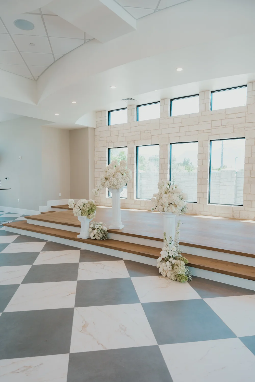 White floral arrangements and natural light in The Oz grand hall