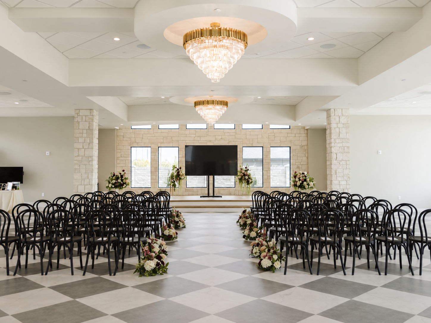 Corporate setup visualization of The Oz grand hall with a large presentation TV at the front of the aisle