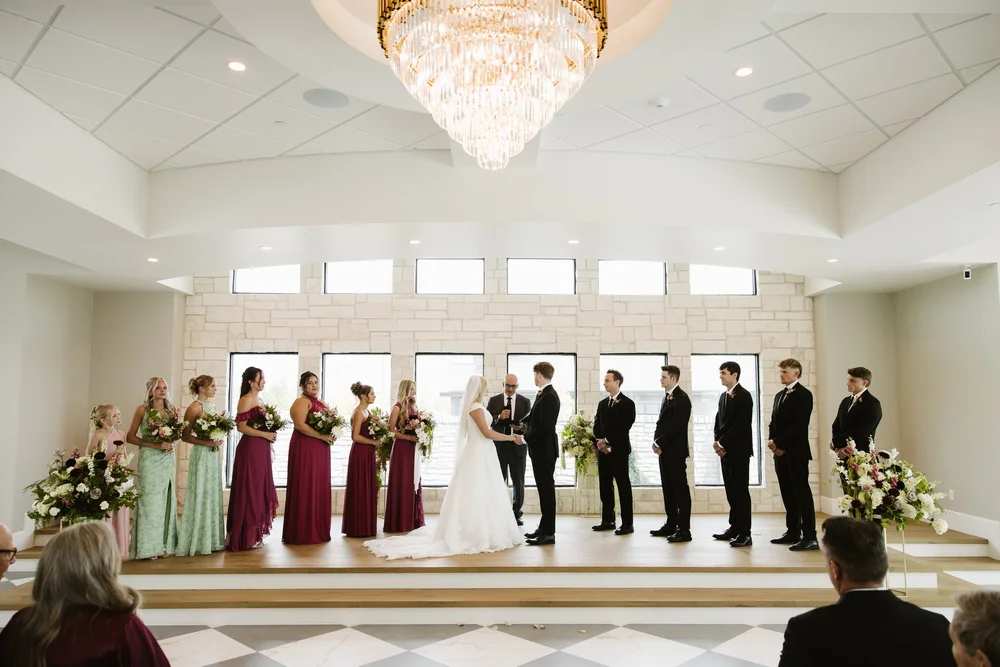 Wedding ceremony beneath the chandeliers at The Oz