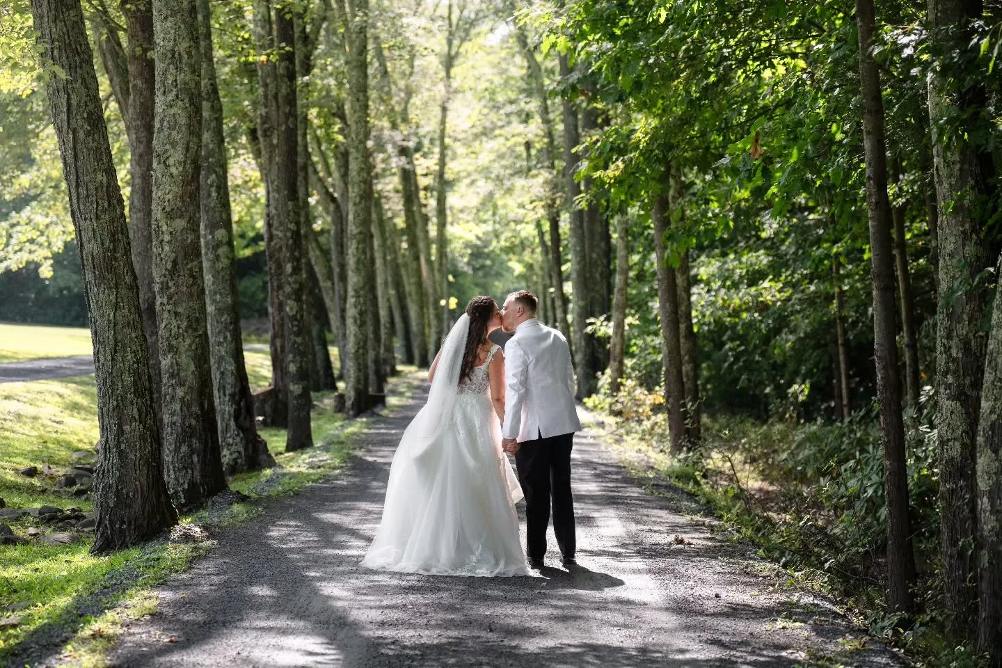 A timeless kiss on a sunlit path, surrounded by love and nature. ❤️✨

Associate shoot @mackeyphoto
 #JustMarried #WeddingBliss #BrideAndGroom #ForeverStartsHere #SunlitLove #HappilyEverAfter #WeddingPhotography #RomanticMoments&quot;