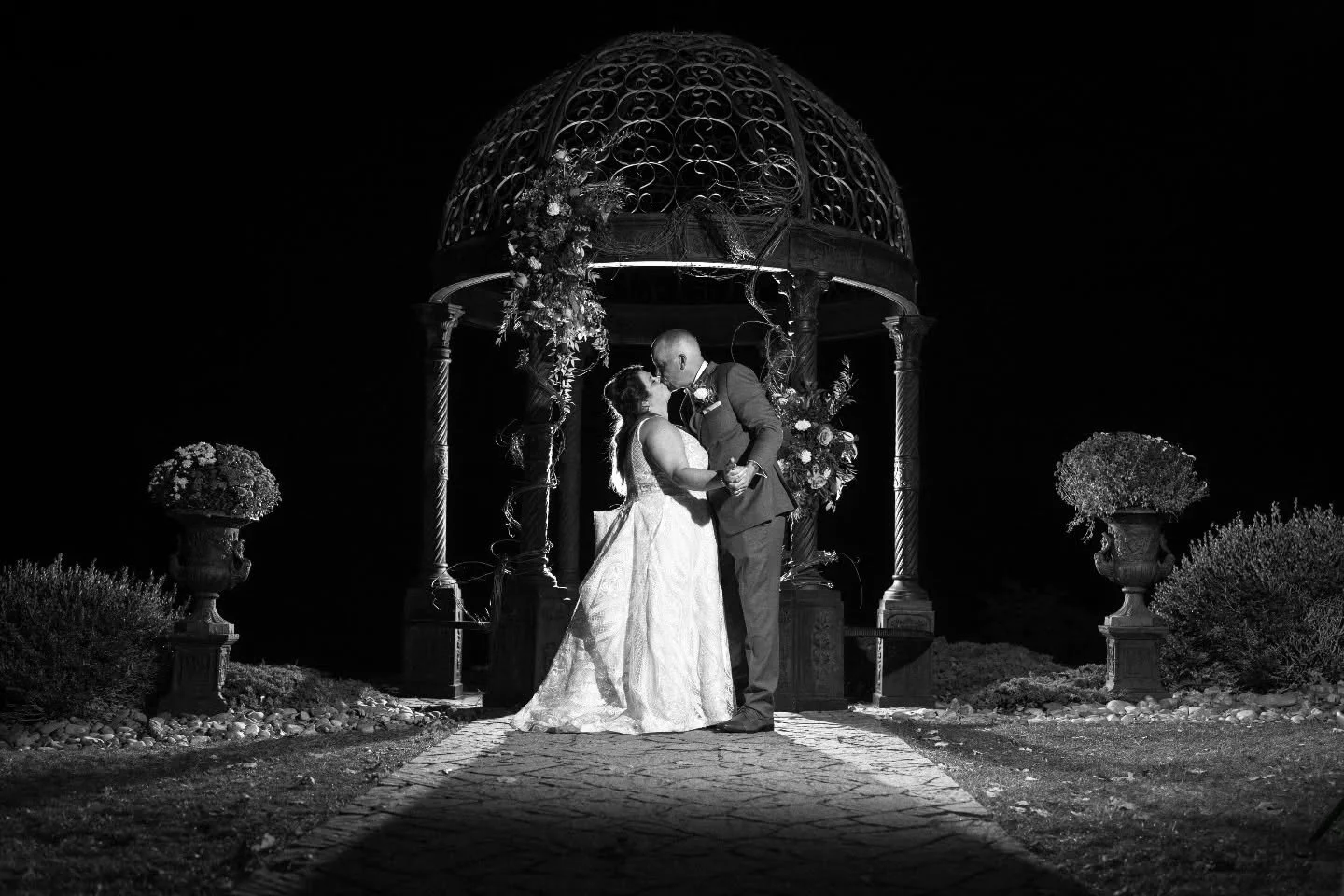 Some moments don&rsquo;t need color to say everything. Timeless, bold, and beautifully theirs.

Shot w/ @mackeyphoto team
#BlackAndWhiteWedding #WeddingPhotography #ClassicRomance #NightPortraits #GazeboKiss #TimelessLove #WeddingInspo #ElegantWeddin