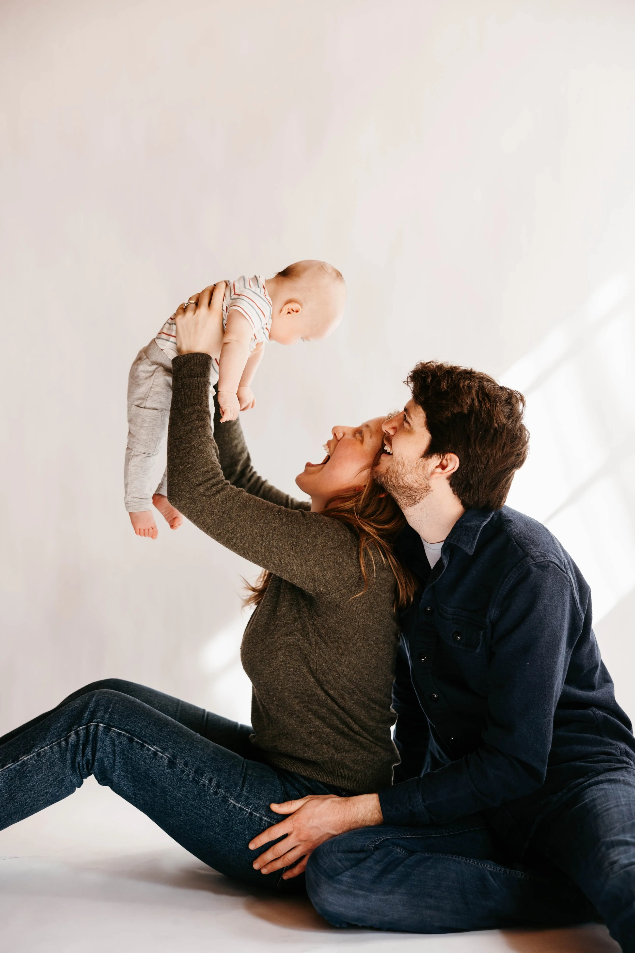 portrait with 3 happy family members, 2 adults and 1 infant
