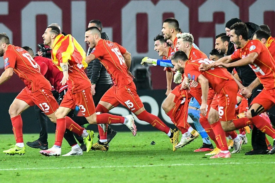 Soccer players in red uniforms celebrating on the field